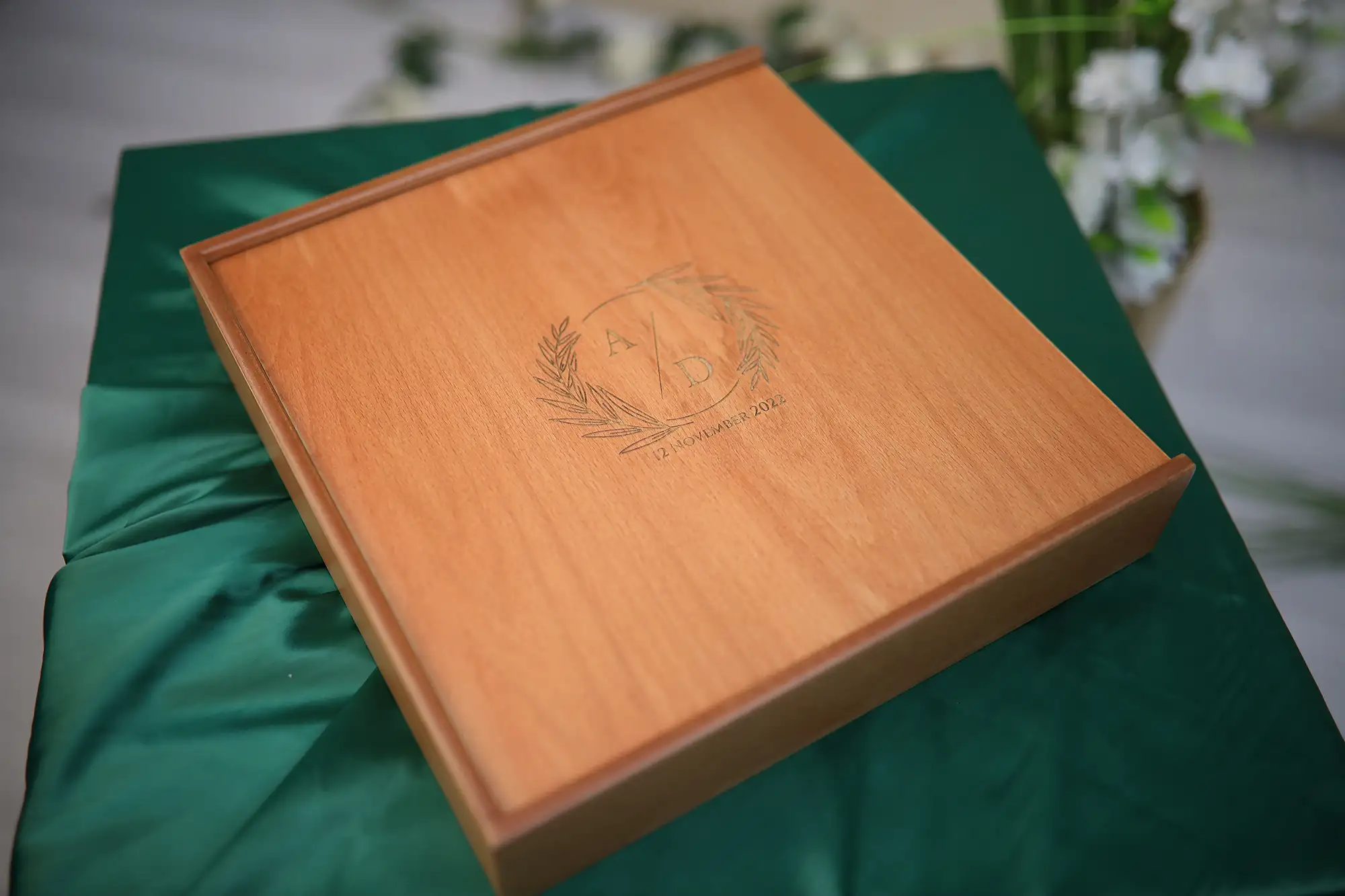Close-up of engraved wooden anniversary album detail