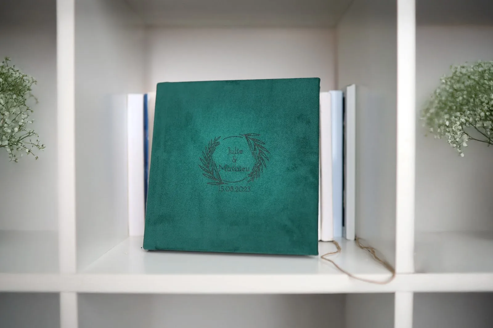 Photo albums neatly stored on a bookshelf, kept safe among books.