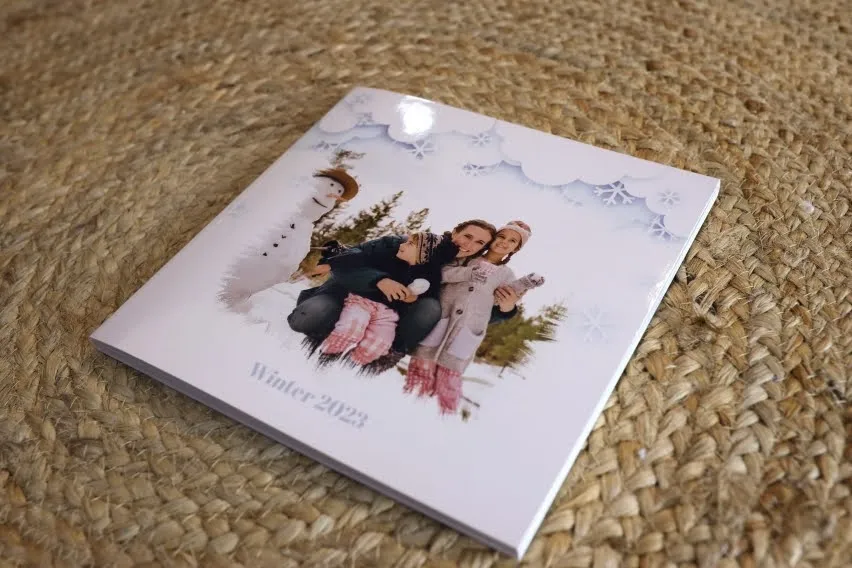 Winter 2023 photo album with a family picture and snowman on the cover.