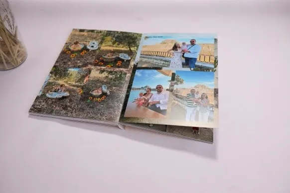 A photo album open to a page with four pictures of a couple enjoying outdoor activities. The photos show them surrounded by nature and in scenic locations, with some images featuring sunflowers.